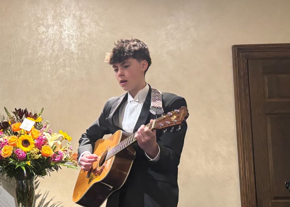 Chloe Moyer performing with a guitar